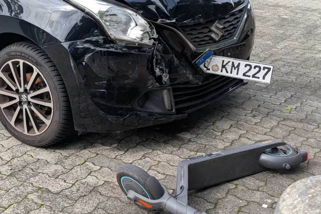 Coche y patinete dañados tras un accidente en la ciudad